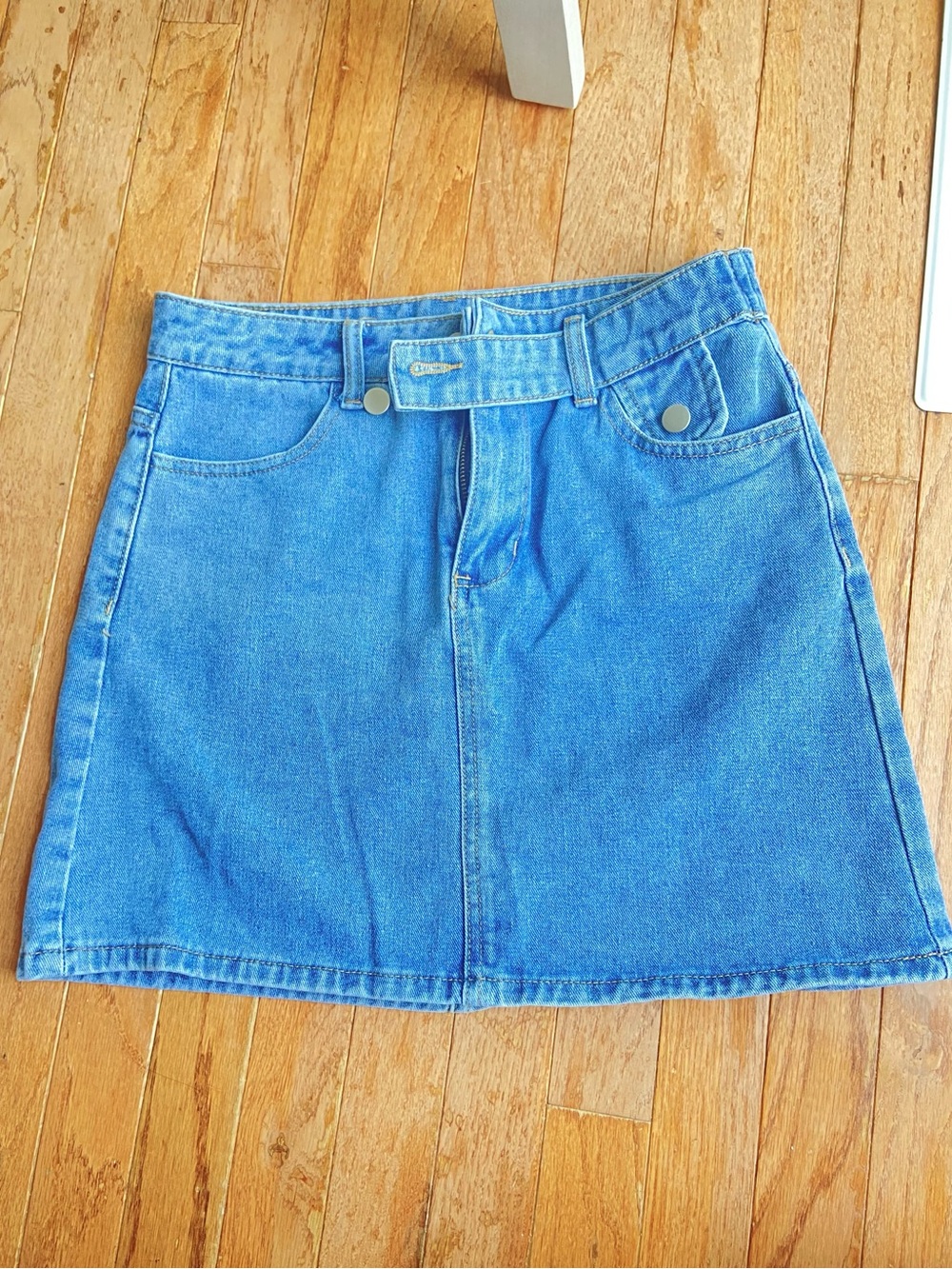 High-Rise Light Blue Denim Mini Skirt with Front Tab Detail